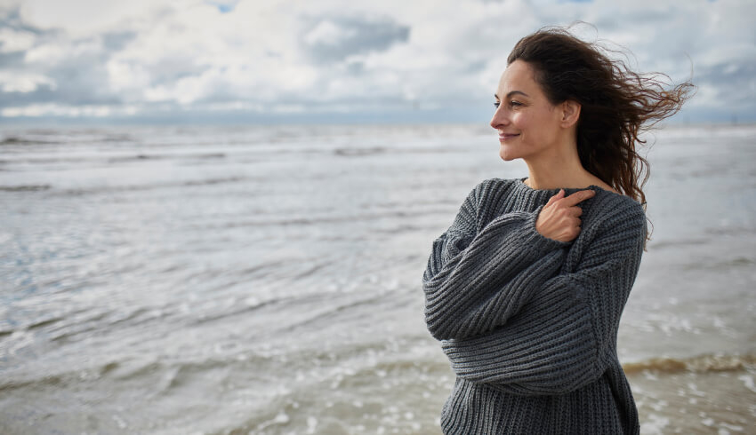 blog-article Woman standing on beach smiling
